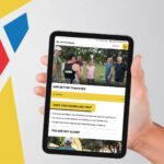 A photo of an iPad being held with the fiftyfitness website on it.