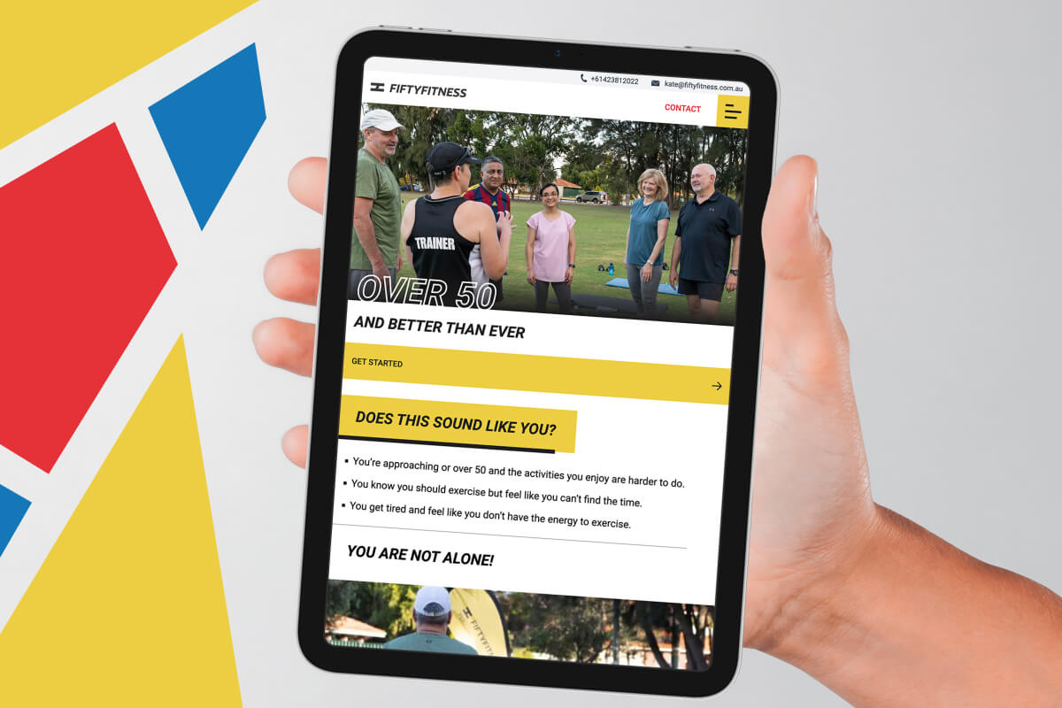 A photo of an iPad being held with the fiftyfitness website on it.